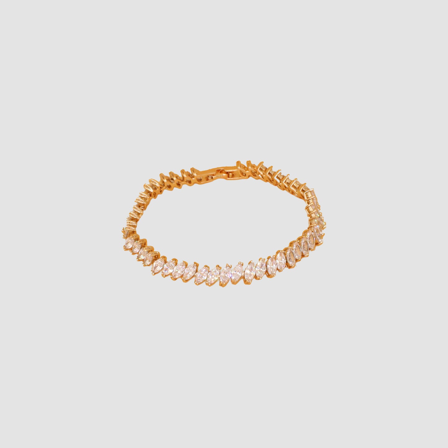 Gold-colored bracelet featuring a row of marquise-cut simulant diamonds.