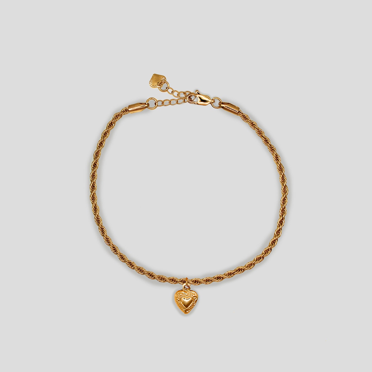 Gold-colored twisted rope chain anklet with the Heart pendent in the center, adjustable clasp, and heart charm.