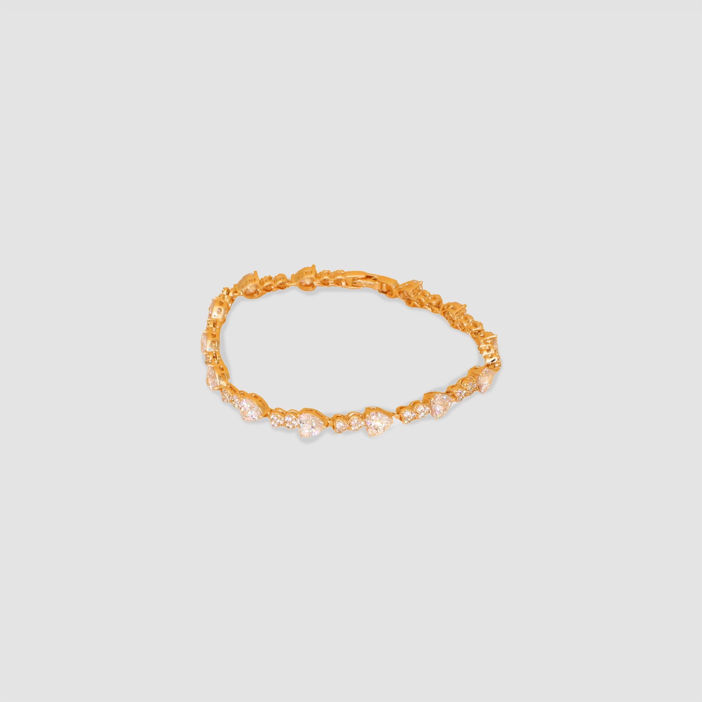 A gold color bracelet that features multiple white hearts lab-grown diamonds all around the bracelet.