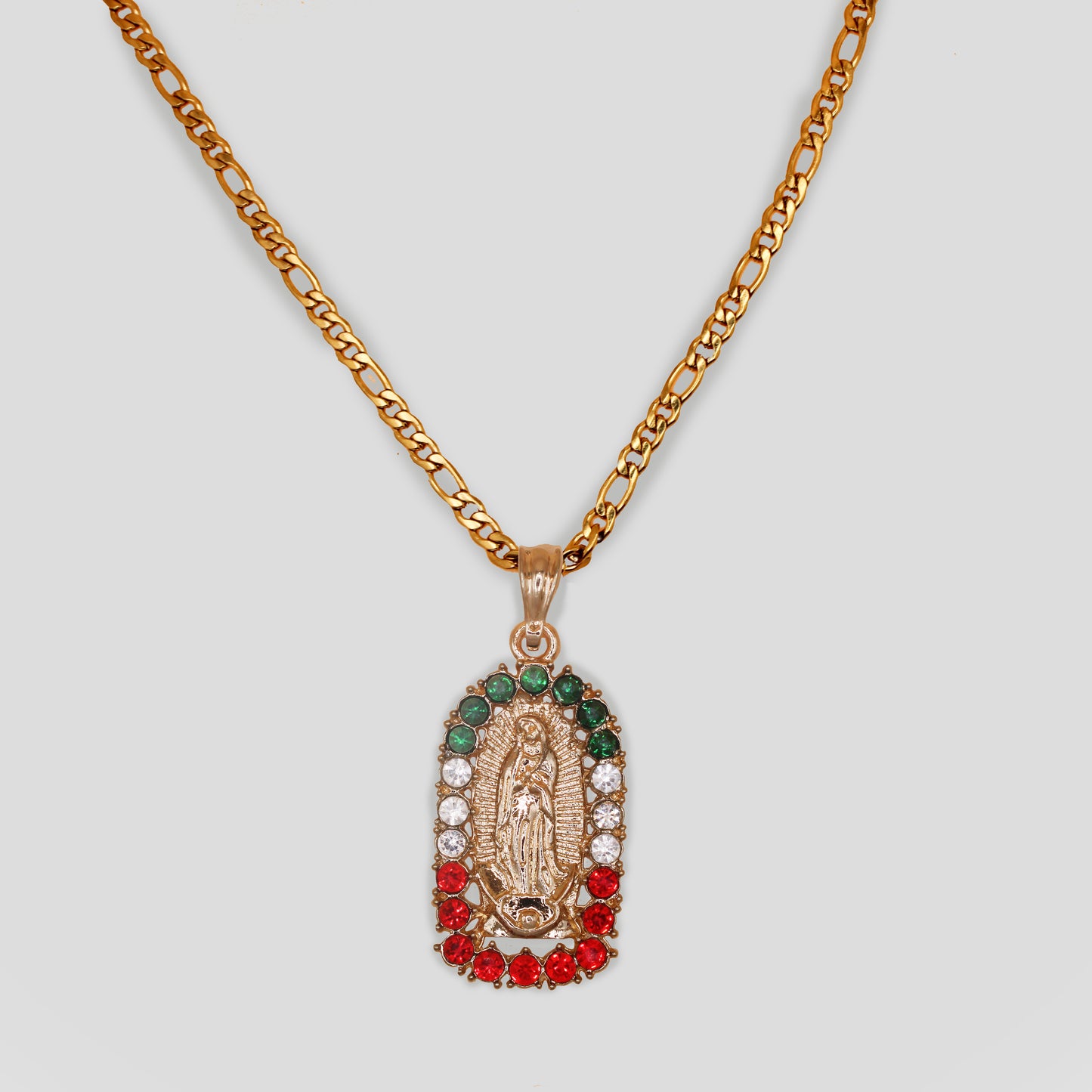 A gold-colored necklace with an oval-shaped Virgin Mary pendant surrounded with Mexican flag color gemstones of green, white, and red.