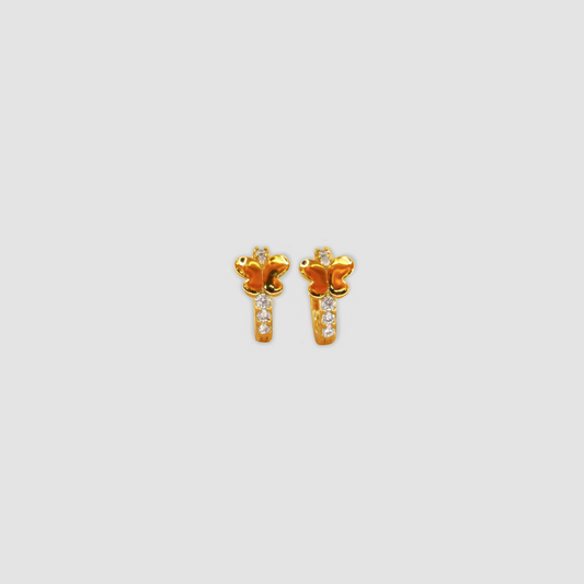 A pair of gold tone earrings with a butterfly silhouette and diamonds.