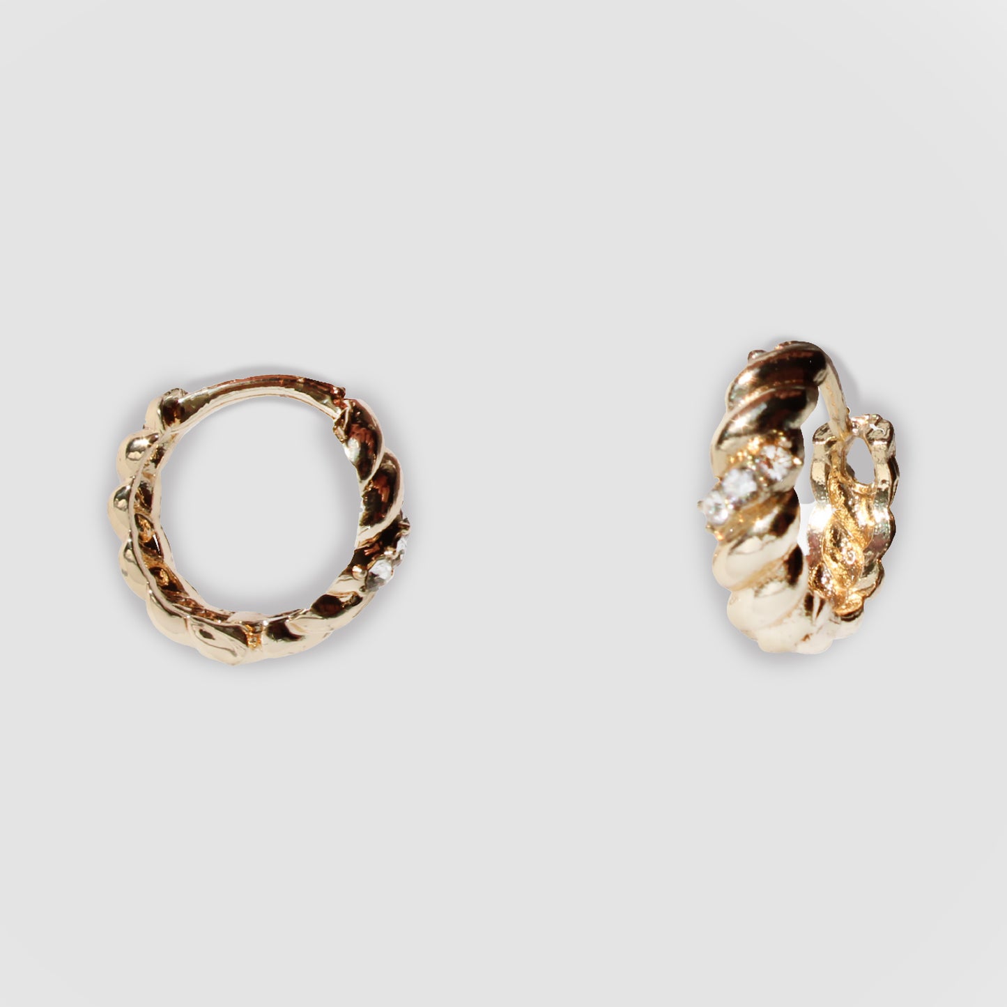 Gold-colored twisted hoop earrings with a textured design and small simulant diamonds. The one the left gave the side view and vertical view of the hoops.