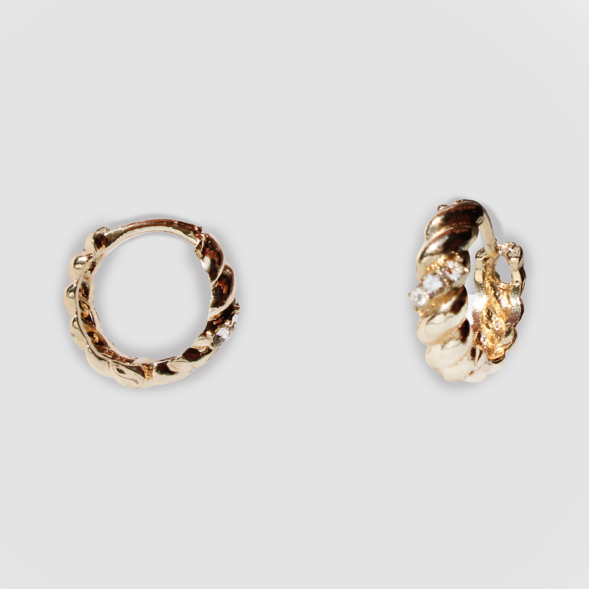 Gold-colored twisted hoop earrings with a textured design and small simulant diamonds. The one the left gave the side view and vertical view of the hoops.