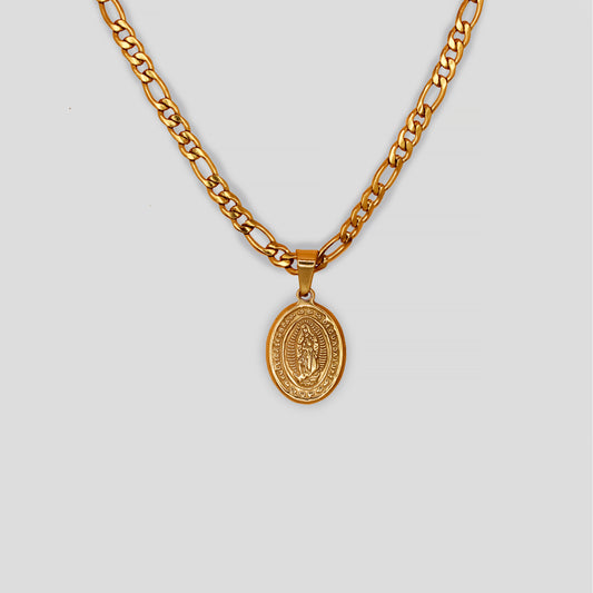 A necklace designed with a figaro chain and a richly detailed, oval-shaped pendant that features the Virgin Mary at its center.