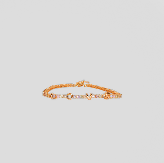 A gold-colored bracelet with the word 'LOVE' spelled out in capital letters, each letter separated by small, multicolored gemstones.