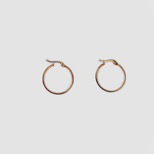 A pair of classic gold-color hoop earrings with a smooth, polished finish.