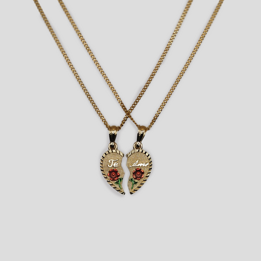 Two gold-tone necklaces featuring matching pendant halves of a broken heart. Each half is engraved with "Te Amo" and adorned with red roses, forming a complete heart when placed together.