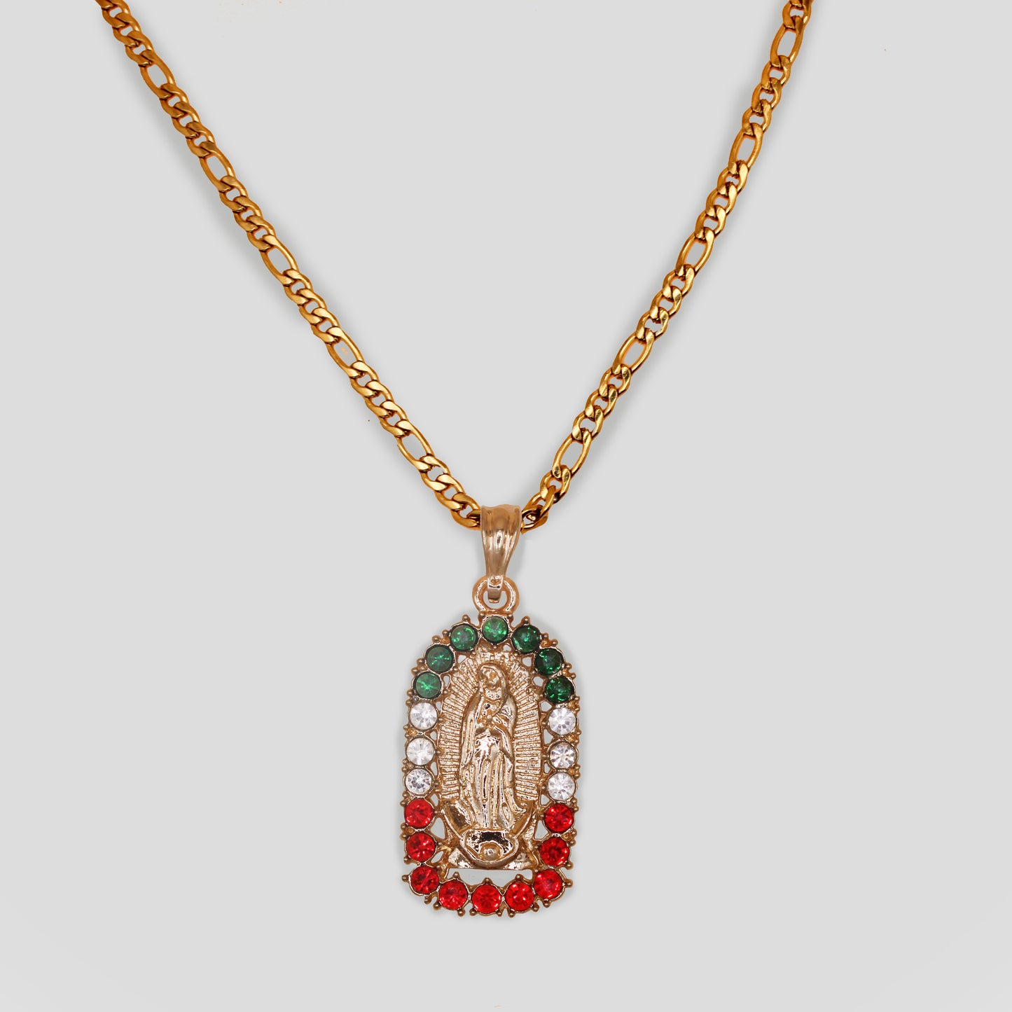 A gold-colored necklace with an oval-shaped Virgin Mary pendant surrounded with Mexican flag color gemstones of green, white, and red. 