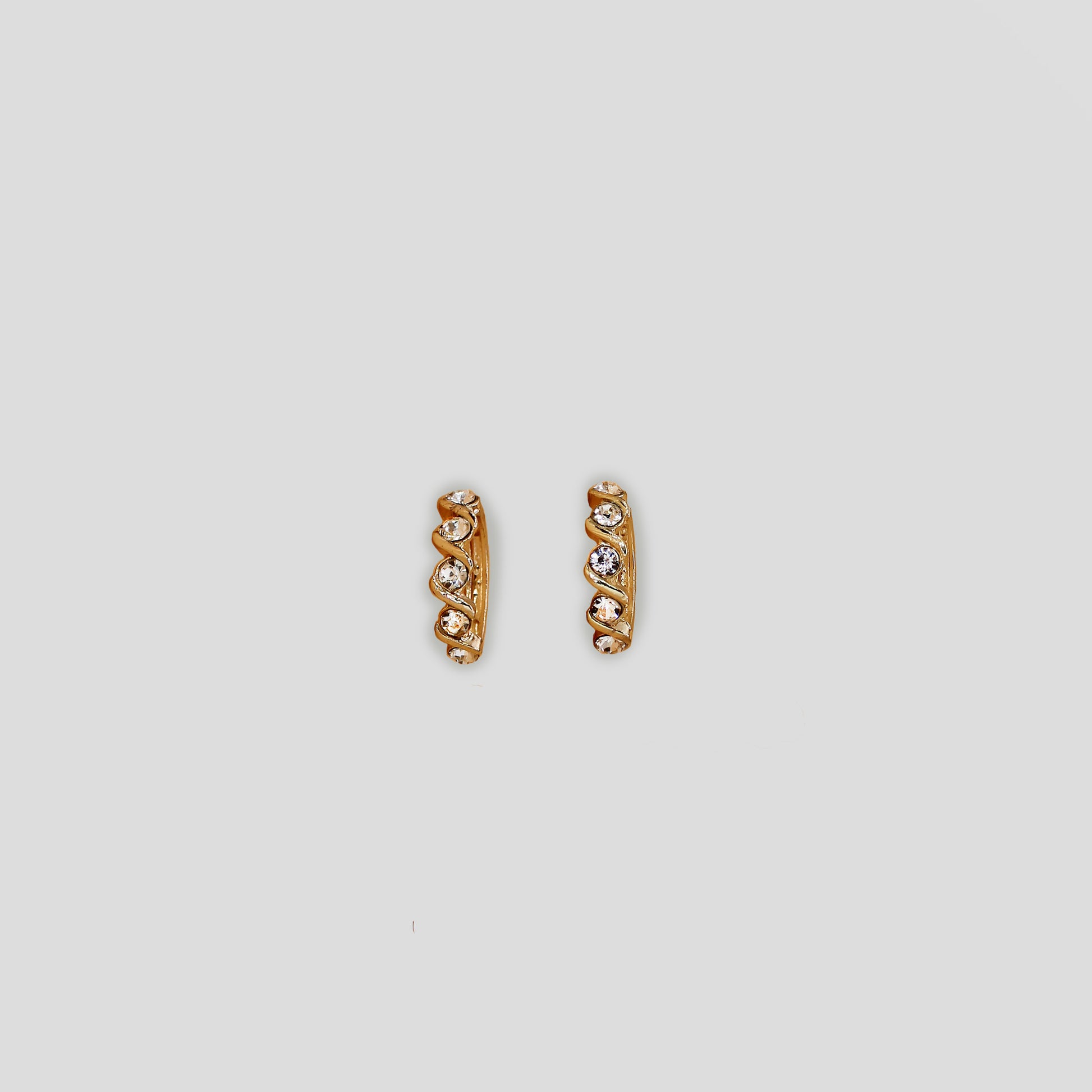 Gold color earrings with white simulant diamonds.