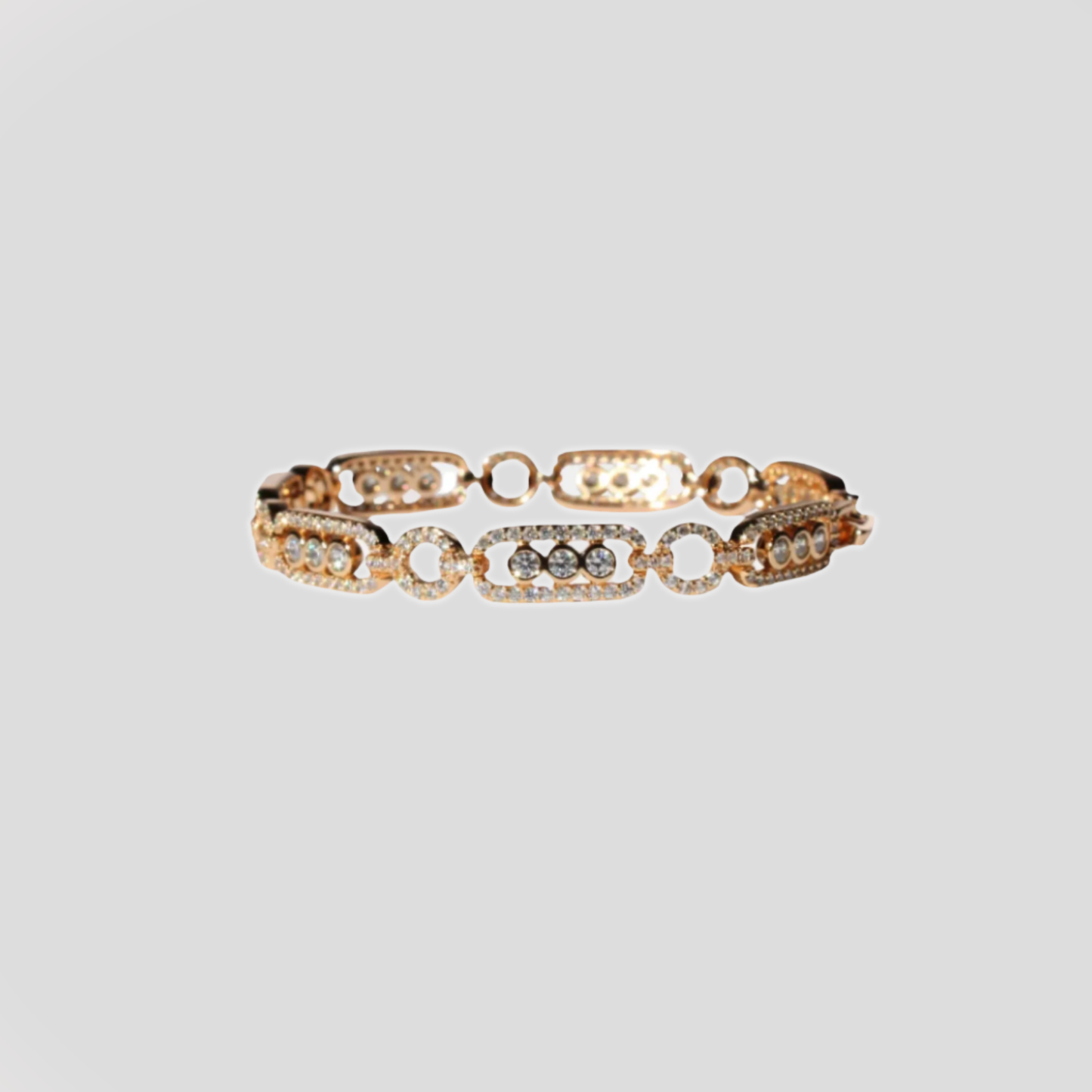 Gold-colored bracelet with circular and rectangular links, adorned with simulant diamonds.